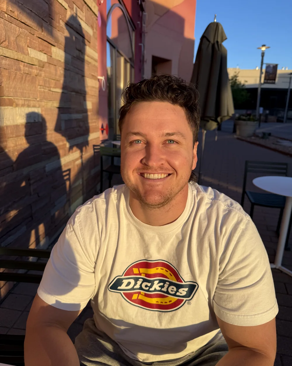 Kaden Jolley smiling outdoors in warm evening light